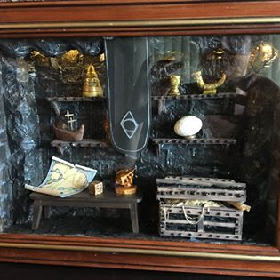 A glassed shadow box with items from the Thieves Guild in the game Skyrim