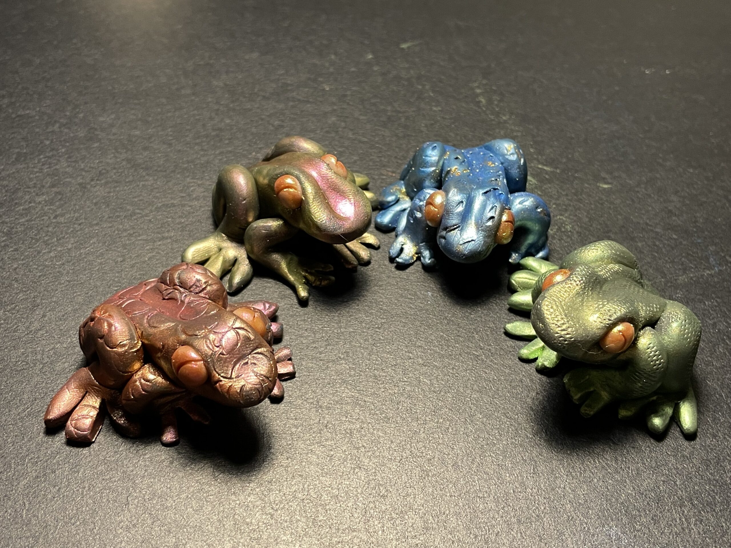 Four polymer clay frogs